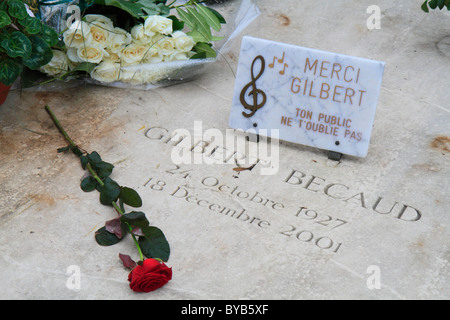 Tomb of Gilbert Becaud with roses and a plaque, Merci Gilbert, Père Lachaise Cemetery, Paris, France, Europe Stock Photo