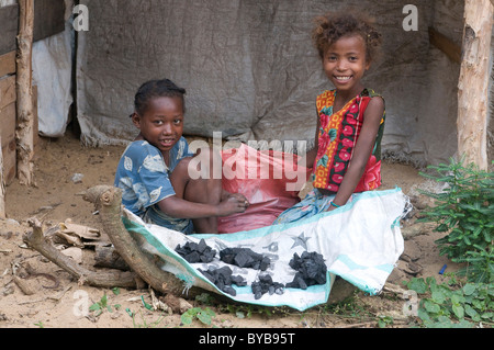 Young kids selling along a road, Fort Dauphin, Taolagnaro, Madagascar, Africa Stock Photo