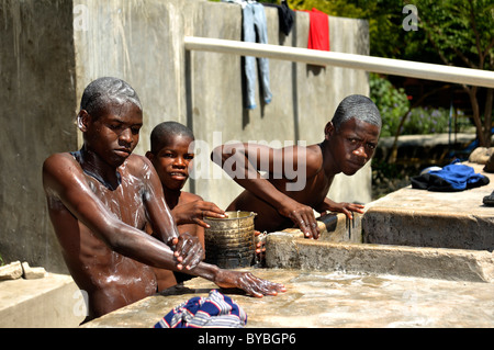 Street children washing, Salesian project Lakay or The House, La Saline district, Port au Prince, Haiti, Central America Stock Photo