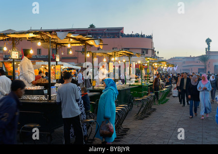 Crowds at the snail snack stall vendors in Place Djemaa el Fna square Marrakech Morocco Stock Photo