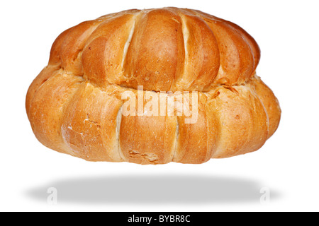 Photo of a white cottage loaf of bread, isolated on a white background with floating shadow. Stock Photo