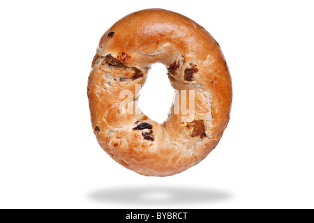 Photo of a cinnamon and raisin bagel, isolated on a white background with floating shadow. Stock Photo