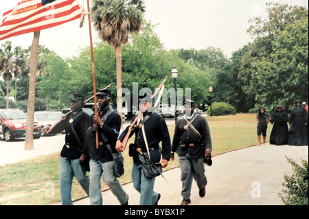 Reenactors carrying U.S. flag at celebration of first Memorial day in 1865 at its site in Hampton Park, Charleston, SC Stock Photo