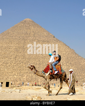 Egypt, tourists riding camels at Giza in Egypt Stock Photo