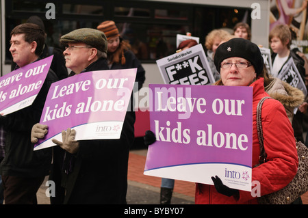 Parents of students at a demonstration against student fee increases, hold signs saying 'Leave our kids alone' Stock Photo
