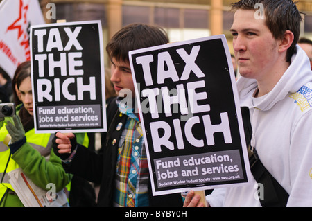 Students protest against university funding cuts and hold placards saying 'Tax the rich. Fund education, jobs and services' Stock Photo