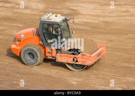 Vibratory soil compactor. HAMM 3000 series in action. Stock Photo