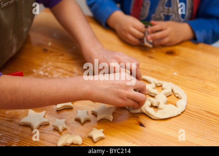 children cutting out shapes in dough Stock Photo