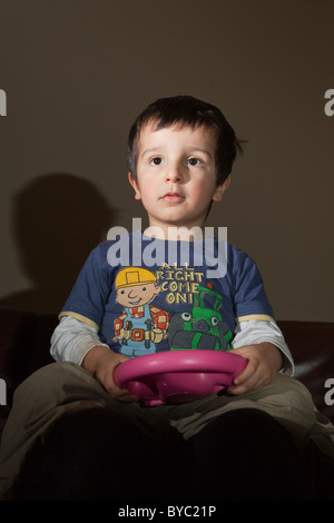 young boy playing alone on Nintendo Wii Stock Photo