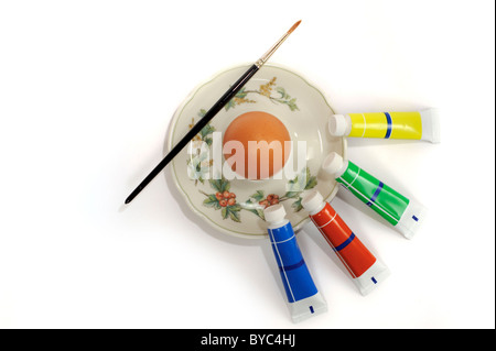 Egg with paint and brush for easter Stock Photo