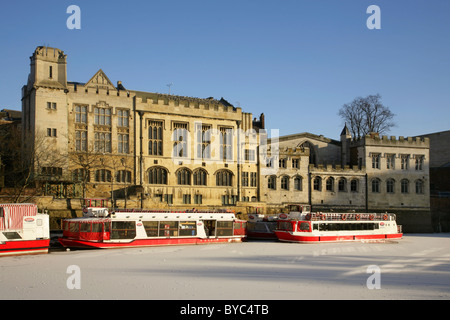 Pleasure boats moored on the frozen River Ouse near Lendal bridge and the Mansion House, York, United Kingdom. Stock Photo