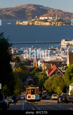 Powell-Hyde cable car with Alcatraz in the distance, San Francisco, CA Stock Photo