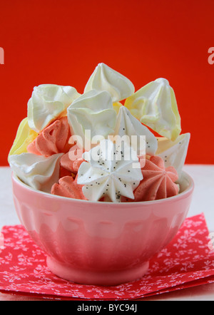 colorful meringue beze cookies in a cup on the table Stock Photo