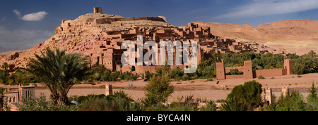 Panorama of ancient city fortress of Ait Benhaddou and blue berbers crossing Wadi Mellah near Ouarzazate Morocco Stock Photo