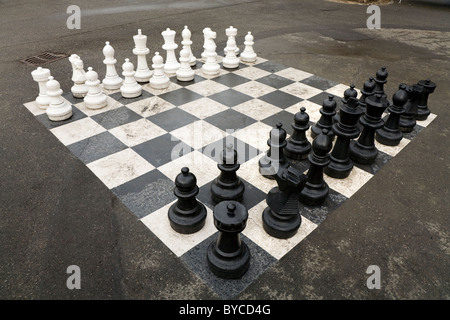 Pieces set out to start / begin a game of oversized / large / giant / big chess in a public park in Geneva / Geneve, Switzerland Stock Photo