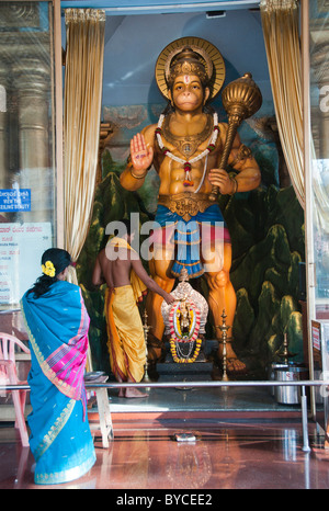 People worshipping a Hanuman statue in the Kadri Manjunatha temple complex in Mangalore India Stock Photo