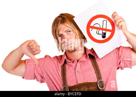 Disapointed Bavarian man in lederhose disagrees to non-smoking-rule. Isolated on white background. Stock Photo