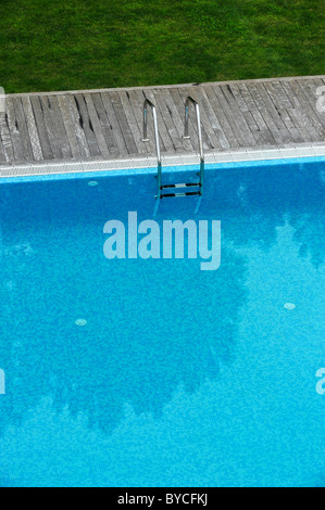 Aerial view of an outdoor swimming pool with wood deck and lawn Stock Photo