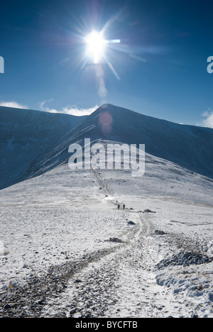 Walkers heading towards Helvellyn Lower Man in winter Stock Photo