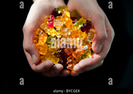 Woman holding Haribo sweets in her hands Stock Photo