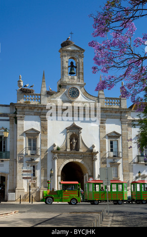 Portugal, the Algarve, the Arco da Vila archway in Faro, with a tourist 'train'. Stock Photo