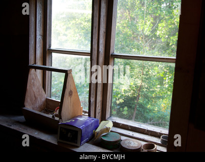 Old wooden toolbox and other stuff on window ledge , Finland Stock Photo