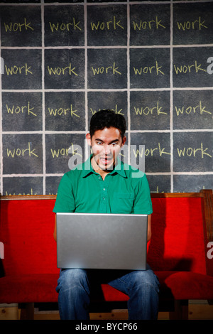 Frustrated office worker overworked workaholic working on laptop. Stock Photo