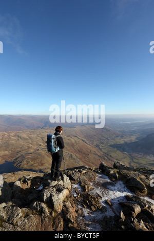 Hill Walker on the Mountain of Harrison Stickle Enjoying the View over Great Langdale Lake District Cumbria UK Stock Photo