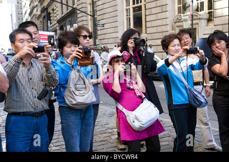 Japanese tourists taking photos with their compact digital cameras, New York City, America, USA Stock Photo
