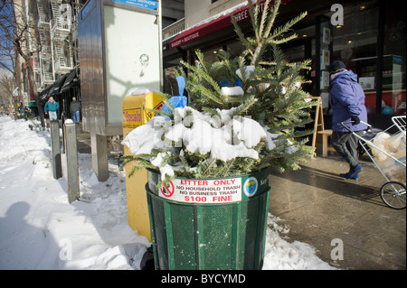 An overflowing trash can is seen in the New York neighborhood of Chelsea Stock Photo