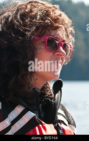 Alaska. Attractive young woman in Five Finger Islands area of Frederick Sound, Tongass National Forest. Southeast Alaska. (MR) Stock Photo