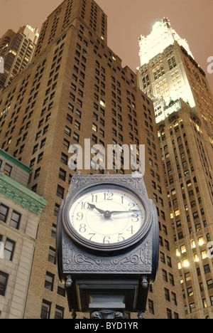 An old fashion clock in downtown Manhattan with skyscrapers behind it. Stock Photo