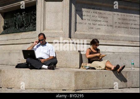 Office workers taking their lunch break in Columbus Circle, New York City, USA Stock Photo