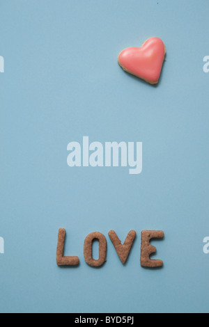 Love, word written with biscuits, with a heart-shaped biscuit Stock Photo