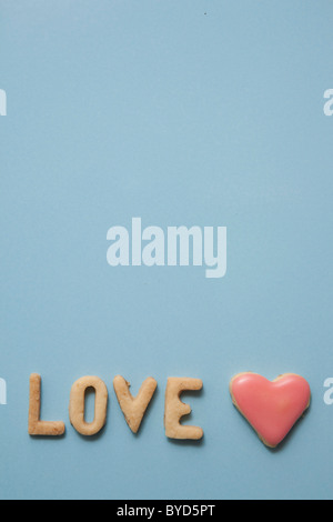 Love, word written with biscuits, with a heart-shaped biscuit Stock Photo