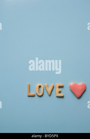 Love, word written with biscuits, with a heart-shaped biscuit Stock Photo