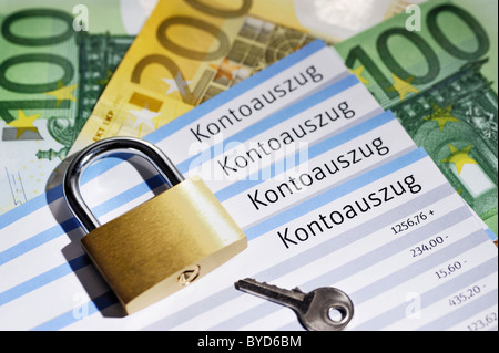 Account statements and a padlock, security of banking data Stock Photo