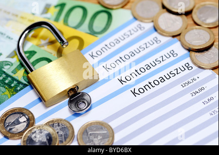 Account statements and a padlock, security of banking data Stock Photo