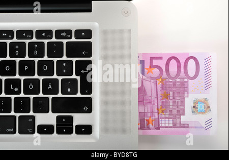 Laptop, PC, with a 500 euro banknote Stock Photo