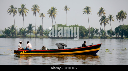 Small ferry on a canal in front of palm trees, Haripad, Alappuzha, Alleppey, Kerala, India, Asia Stock Photo