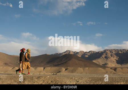 Two women in the mountainous landscape around Murgab, Pamir Mountains, Tajikistan, Central Asia