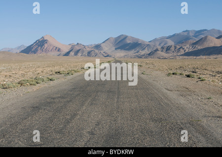 Pamir Highway leading into the wilderness, Pamir Mountains, Tajikistan, Central Asia Stock Photo