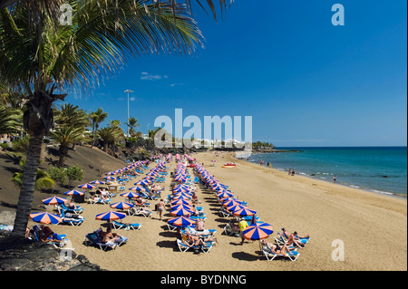 Beach umbrellas on the sandy beach, Playa Grande, Puerto del Carmen, Lanzarote, Canary Islands, Spain, Europe Stock Photo