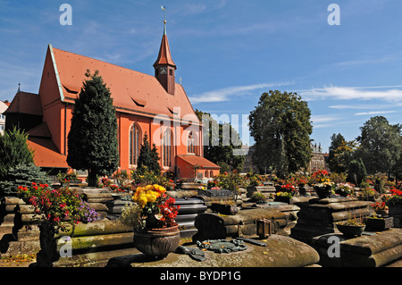 Old graves on the Johannisfriedhof cemetery, founded in the 13th century, St Johannis-Kirche church at the back Stock Photo