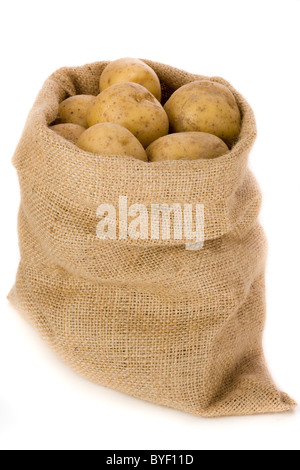 Potatoes in burlap bag agaist white background Stock Photo