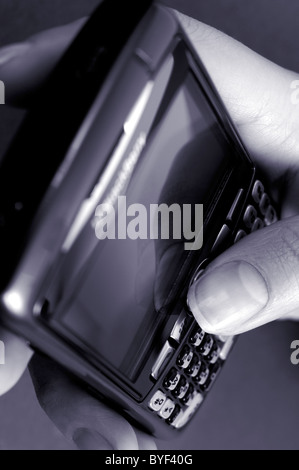 Hand with BlackBerry 8310 Curve Smartphone Stock Photo