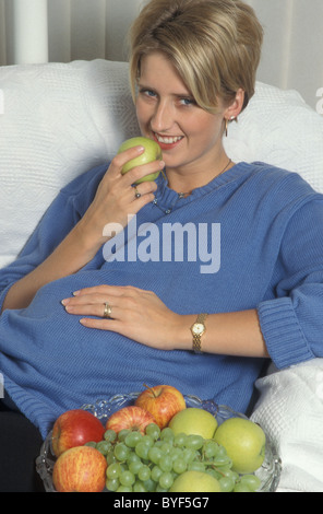 pregnant woman eating healthy diet of fruit Stock Photo