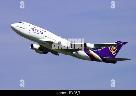 Boeing 747 jumbo jet operated by Thai Airways climbing out after take off from London Heathrow Airport Stock Photo