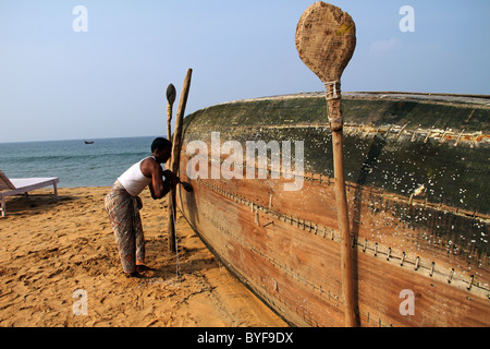 man repairing fishing boat Stock Photo