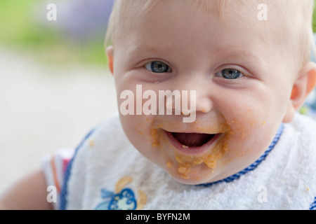 Close up of baby with dirty face after eating